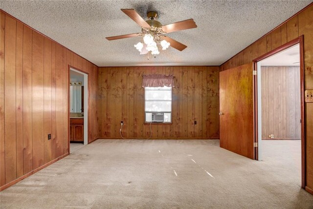 5802 Riley Dr, Corpus Christi, TX 78412 - carpeted spare room with wood walls, ceiling fan, cooling unit, and a textured ceiling