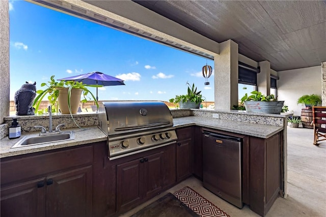 view of patio / terrace featuring grilling area, sink, and an outdoor kitchen