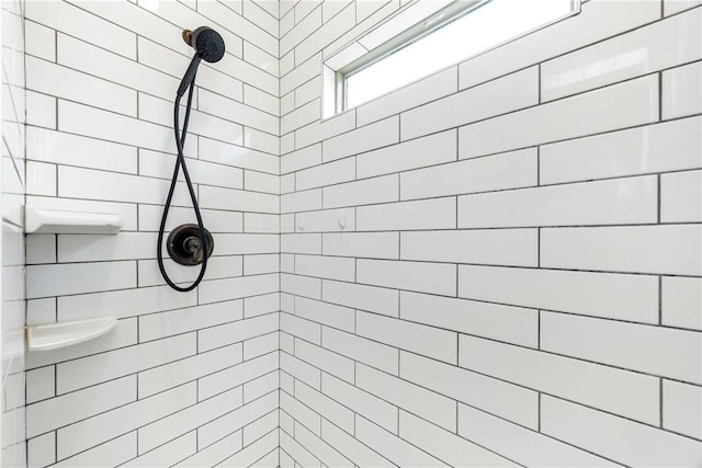 bathroom with tiled shower