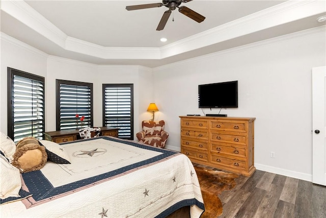 bedroom featuring a tray ceiling, ceiling fan, crown molding, and dark hardwood / wood-style floors