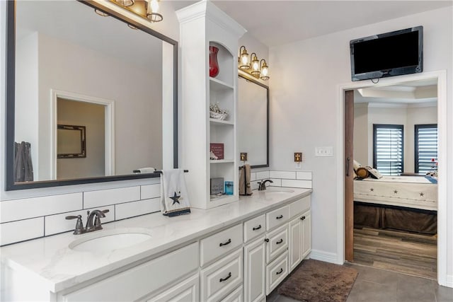 bathroom featuring tile patterned flooring, vanity, and decorative backsplash