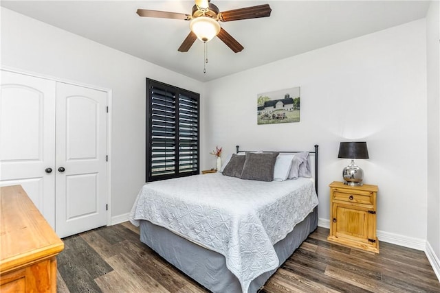 bedroom featuring ceiling fan, dark hardwood / wood-style flooring, and a closet