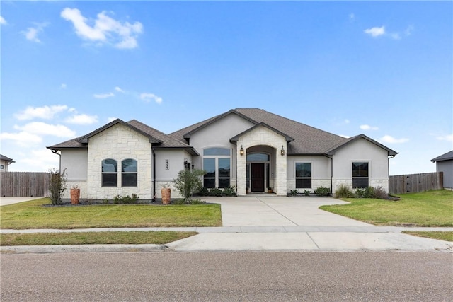 french provincial home with a front lawn