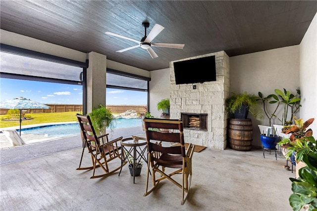 view of patio / terrace featuring a fenced in pool, ceiling fan, and pool water feature