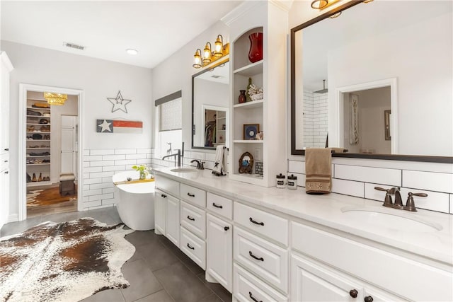 bathroom with vanity, tile patterned floors, tile walls, and a bathing tub