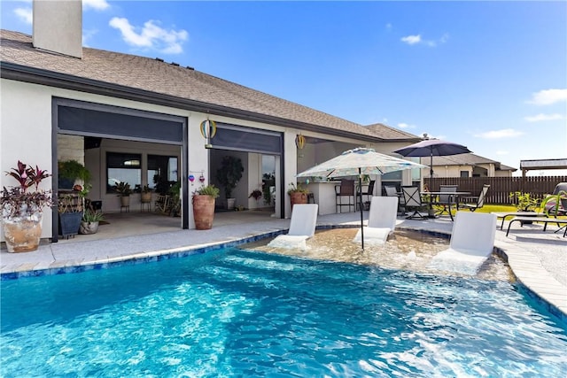 view of swimming pool with a patio area and an outdoor bar