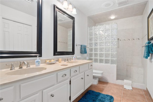 bathroom featuring toilet, tile patterned flooring, and vanity