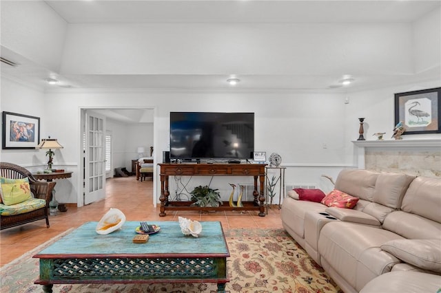 living room featuring light tile patterned floors and crown molding