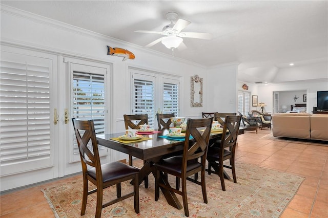 dining area with ceiling fan, light tile patterned floors, ornamental molding, and french doors