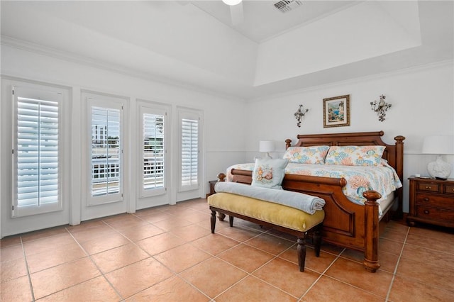 tiled bedroom featuring ceiling fan, crown molding, a raised ceiling, and access to outside