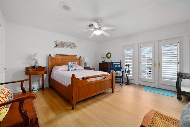 bedroom featuring ceiling fan, access to exterior, light hardwood / wood-style floors, and french doors