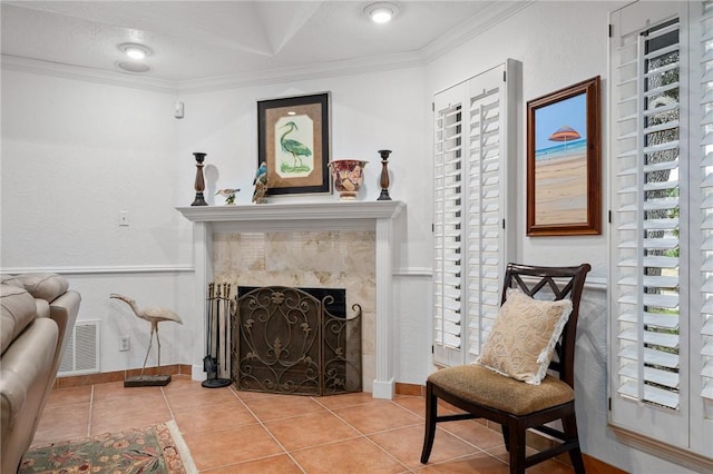 sitting room with tile patterned flooring, a premium fireplace, and ornamental molding