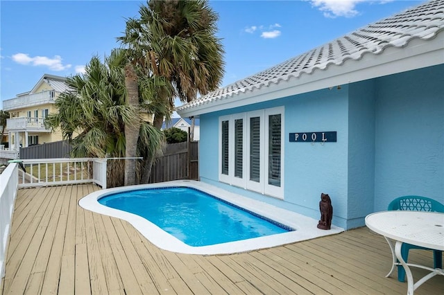 view of swimming pool with a deck