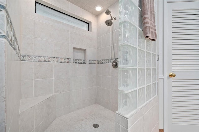 bathroom with tiled shower