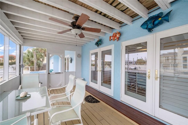 sunroom / solarium with beam ceiling, french doors, and ceiling fan