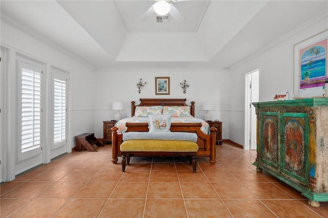 bedroom with ceiling fan, multiple windows, and a tray ceiling