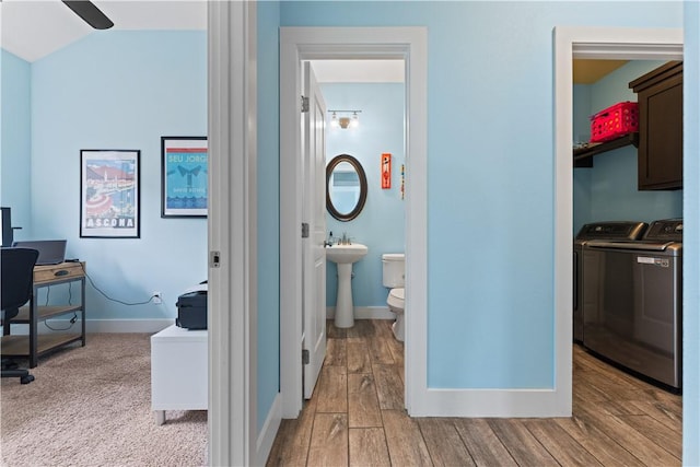 7338 Allman Dr, Corpus Christi, TX 78414 - hallway with separate washer and dryer, a desk, light wood-style floors, and vaulted ceiling