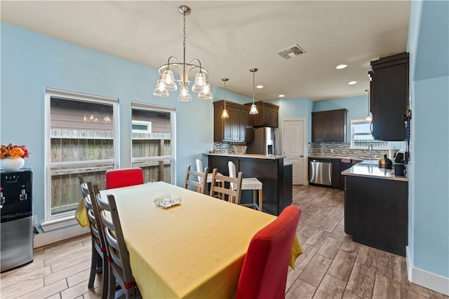 7338 Allman Dr, Corpus Christi, TX 78414 - dining space with light wood-style flooring, a chandelier, and recessed lighting