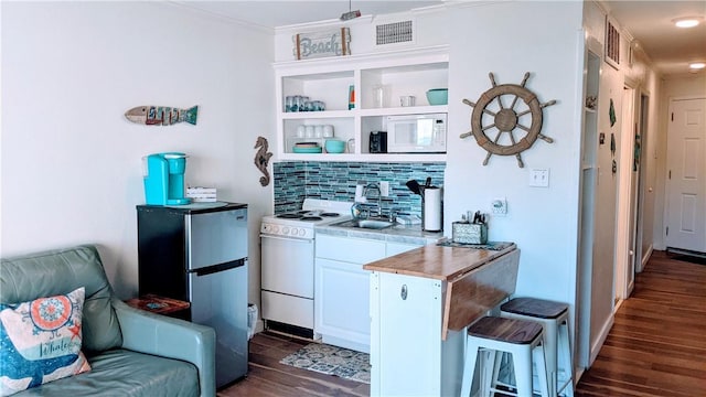 3938 Surfside Blvd Unit 2236, Corpus Christi, TX 78402 - kitchen featuring white appliances, dark wood finished floors, a sink, decorative backsplash, and a kitchen bar