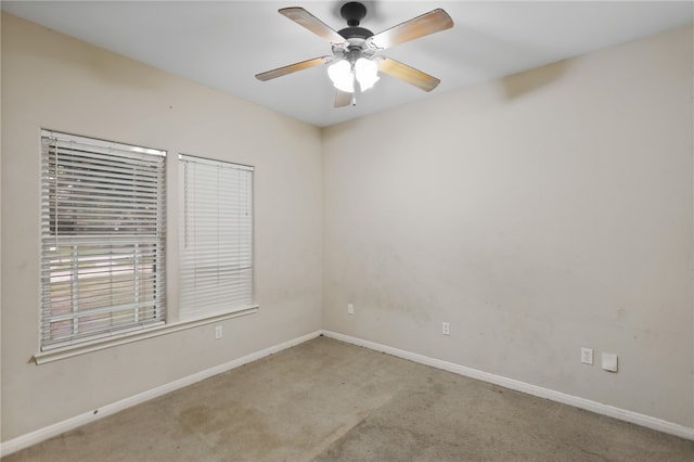 carpeted spare room with ceiling fan