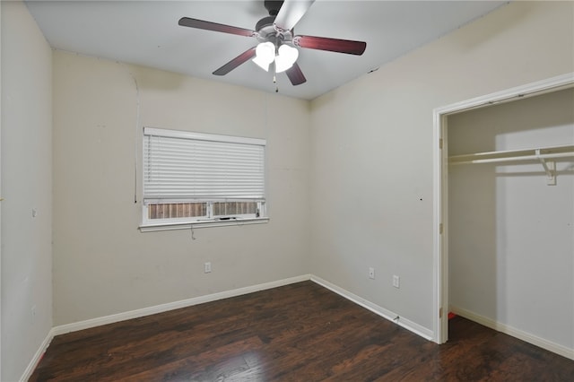 unfurnished bedroom with dark hardwood / wood-style flooring, a closet, and ceiling fan