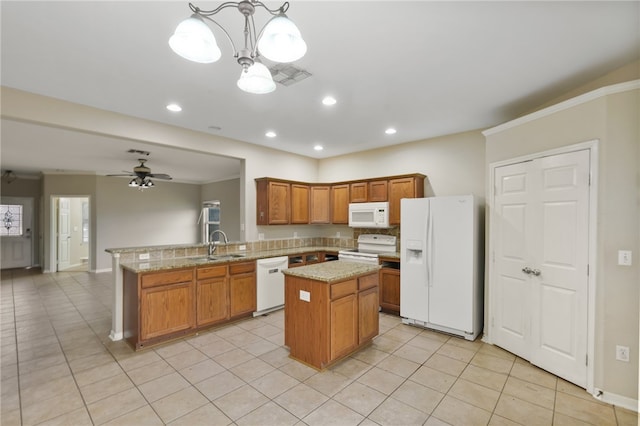 kitchen with kitchen peninsula, light tile patterned floors, pendant lighting, white appliances, and ceiling fan with notable chandelier