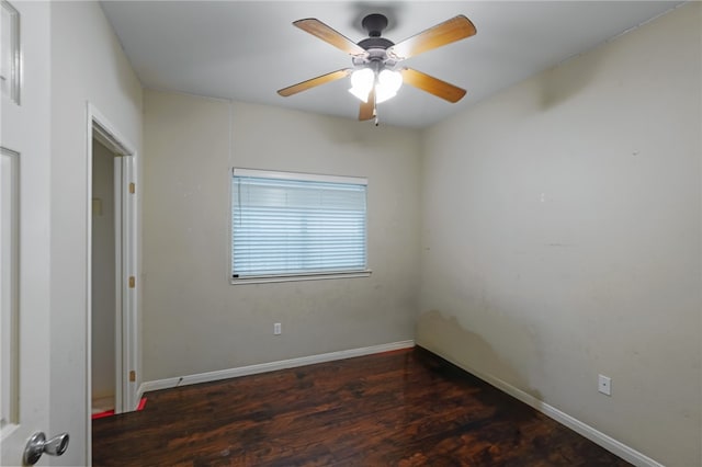 unfurnished room featuring dark wood-type flooring and ceiling fan