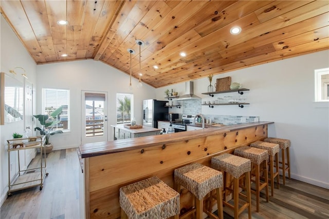 kitchen with dark wood-type flooring, appliances with stainless steel finishes, ventilation hood, and wooden ceiling