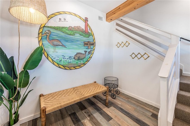 interior space featuring beamed ceiling and hardwood / wood-style floors