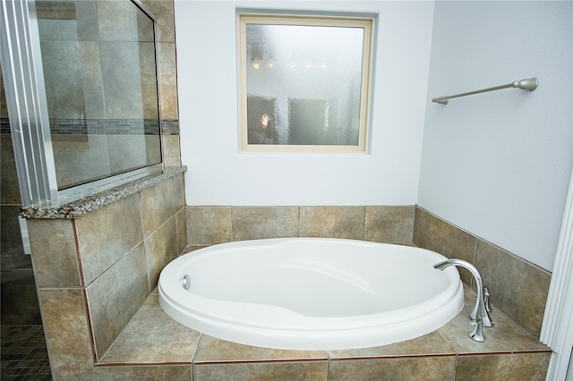 bathroom with tiled bath