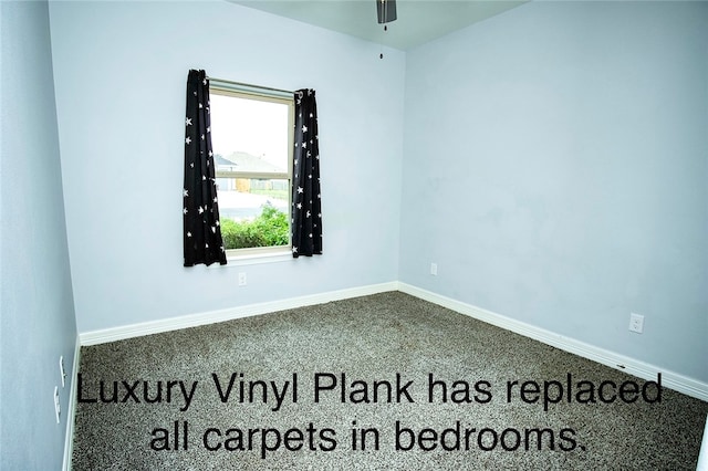 carpeted spare room featuring ceiling fan