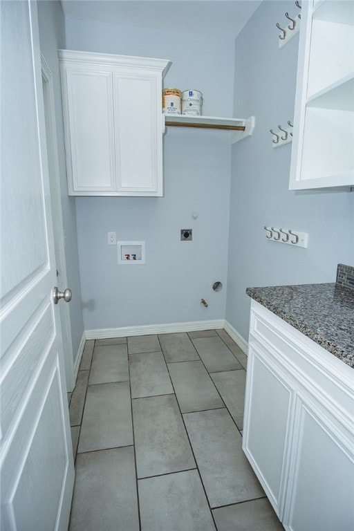 laundry room with electric dryer hookup, cabinets, gas dryer hookup, light tile patterned floors, and hookup for a washing machine