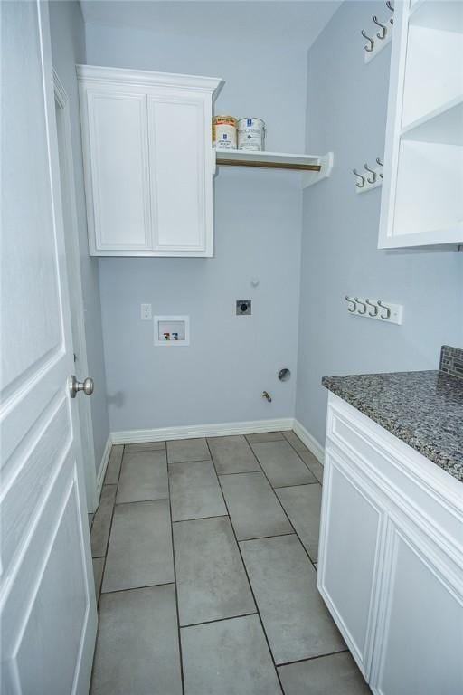 15414 Dyna St, Corpus Christi, TX 78418 - washroom featuring electric dryer hookup, gas dryer hookup, washer hookup, cabinet space, and light tile patterned floors
