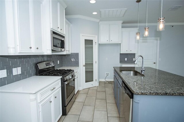 15414 Dyna St, Corpus Christi, TX 78418 - kitchen with stainless steel appliances, a kitchen island with sink, white cabinets, and recessed lighting