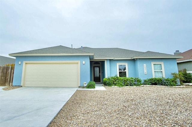 15414 Dyna St, Corpus Christi, TX 78418 - ranch-style house featuring driveway, an attached garage, stucco siding, and a shingled roof