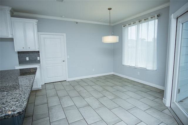 unfurnished dining area featuring ornamental molding