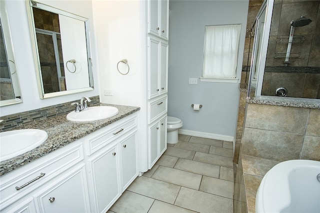 full bathroom featuring toilet, shower with separate bathtub, vanity, and tile patterned flooring