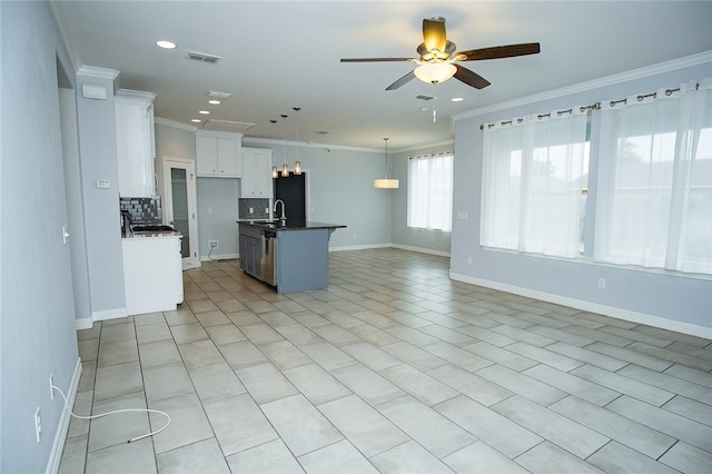 kitchen featuring white cabinets, an island with sink, ceiling fan, crown molding, and decorative light fixtures