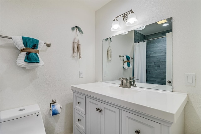 bathroom featuring vanity, toilet, and a shower with shower curtain