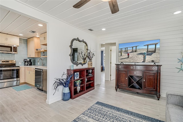 kitchen featuring stainless steel appliances, sink, and ceiling fan