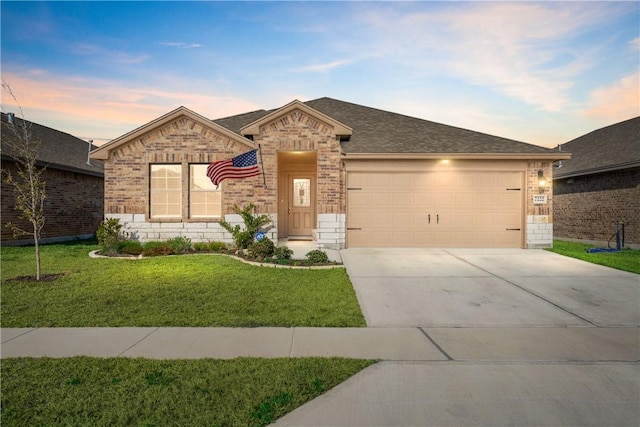 single story home featuring a garage and a yard