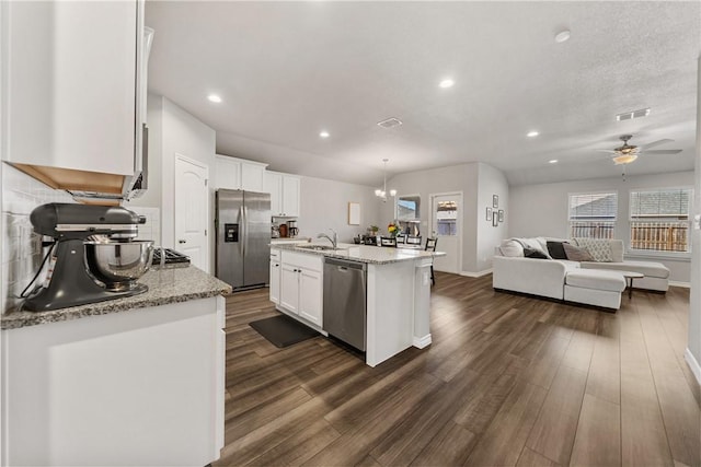 kitchen with a kitchen island with sink, sink, white cabinetry, and appliances with stainless steel finishes