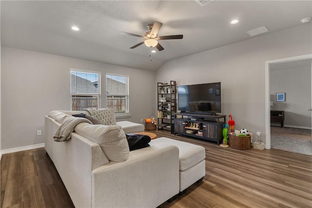 living room featuring hardwood / wood-style flooring, vaulted ceiling, and ceiling fan