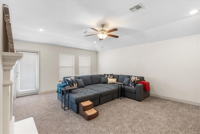 carpeted living area featuring ceiling fan, baseboards, visible vents, and recessed lighting