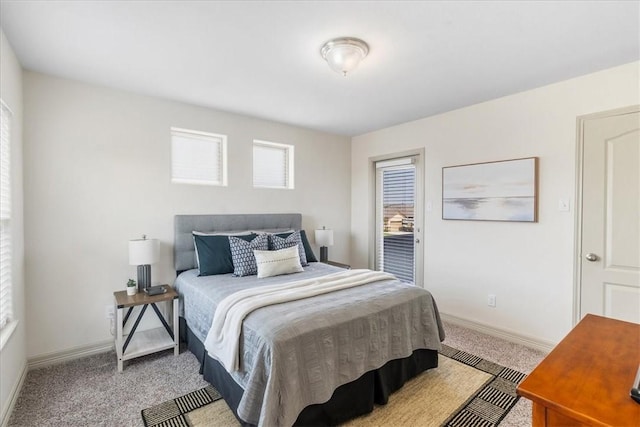 carpeted bedroom featuring baseboards