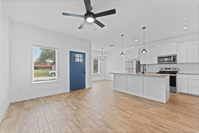 4209 Walnut Hills Dr, Corpus Christi, TX 78413 - kitchen featuring appliances with stainless steel finishes, backsplash, white cabinetry, a chandelier, and light wood-type flooring