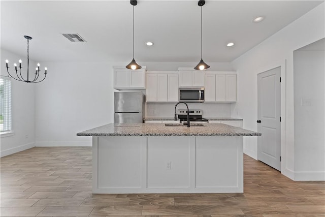 4209 Walnut Hills Dr, Corpus Christi, TX 78413 - kitchen with stainless steel appliances, a sink, tasteful backsplash, white cabinets, and baseboards