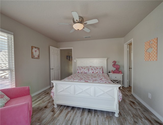 bedroom with ceiling fan and light hardwood / wood-style flooring