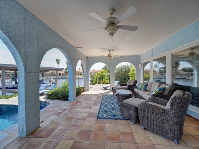 view of patio featuring a water view, outdoor lounge area, and ceiling fan