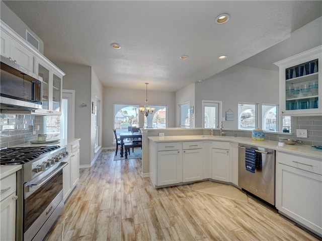 kitchen with white cabinetry, decorative backsplash, and appliances with stainless steel finishes